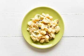 Potato salad with egg, pickle, onion with mayonnaise and yogurt