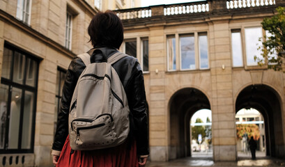 Attractive Woman Walks In City With Backpack, Looking Around