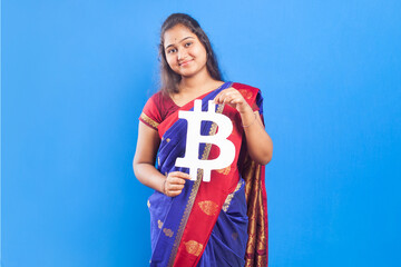 women in saree holding bitcoin sign in blue background