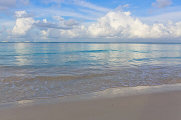 Tropical paradise beach with white sand and blue sky.