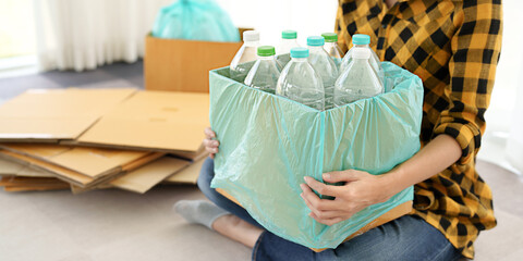 Recycling Plastic Environment conceptual, woman with plastic bottle on paper bin.