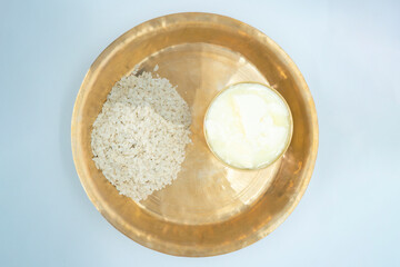 A copper plate and bowl of Dahi Chiura aka Yoghurt and Rice Flakes for Paddy Plantation Celebration Asaar 15 Dahi Chiura Day in Nepal
