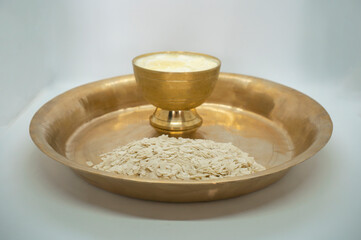 A copper plate and bowl of Dahi Chiura aka Yoghurt and Rice Flakes for Paddy Plantation Celebration Asaar 15 Dahi Chiura Day in Nepal