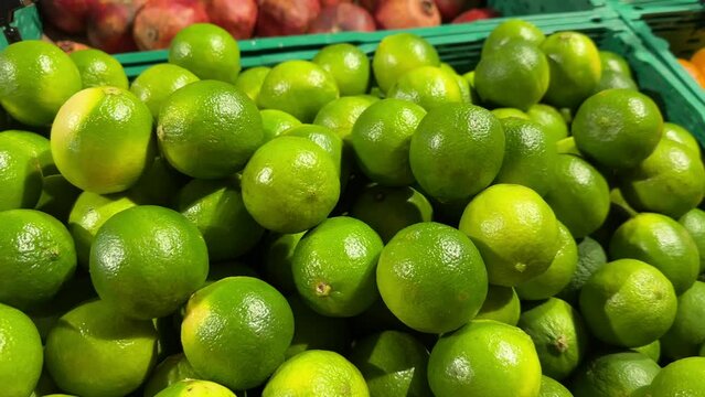 Slow motion close-up of limes for sale in the supermarket, glocery. Natural healthy food.