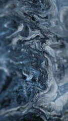 Obraz premium Shiny paint cascade. Wet glitter texture. Blur gray silver color shimmering metallic grain particles ink pigment fluid mix flow abstract art background.