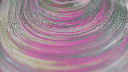 Shimmering swirl. Paint layers. Defocused pink gray color sparkling grain texture ink round ripple curves abstract art background.