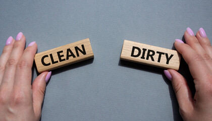 Clean or Dirty symbol. Concept word Clean or Dirty on wooden blocks. Man hand. Beautiful grey background. Gender and Clean or Dirty concept. Copy space