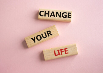 Change your Life symbol. Wooden blocks with words Change your Life. Beautiful pink background. Business and Change your Life concept. Copy space.