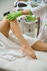 Clinic employee performs procedure for treating the vaginal walls of patient