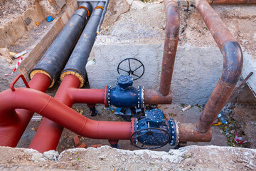 A system of new large diameter water pipes with insulation and valves in the ground.