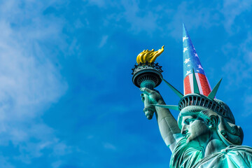 Fototapeta premium The statue of Liberty wearing a celebration party hat. American 4th July celebration event