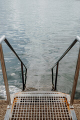 stainless steel steps leading to sea