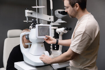 Young women eyesight test refractometer eye in ophthalmology. Doctor use optometry machine control of retina of patient