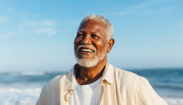 Blissful elderly man smiling by the ocean