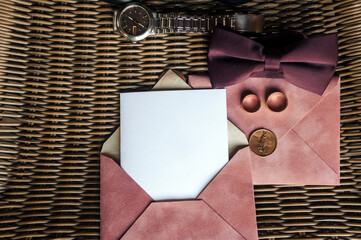 Wedding set, accessories, groom's details: bow tie, envelope, invitation, white sheet of paper,...