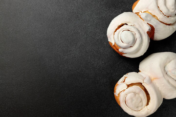 Fragrant Cinnabons with cream on a gray background