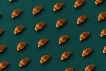 Pattern of baked croissants with a turquoise background. Delicious pastries