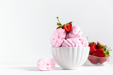 pink strawberry marshmallows in a beautiful white plate on a white background