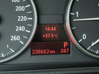 A close-up shot of the car's dashboard showing a very high outside temperature of 37.5 Celsius