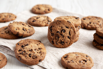 Homemade Gooey Chocolate Chip Cookies on a white wooden background, low angle view.