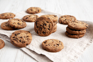 Homemade Gooey Chocolate Chip Cookies on a white wooden background, low angle view.