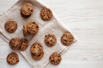 Homemade Gooey Chocolate Chip Cookies on a white wooden background, top view. Copy space.