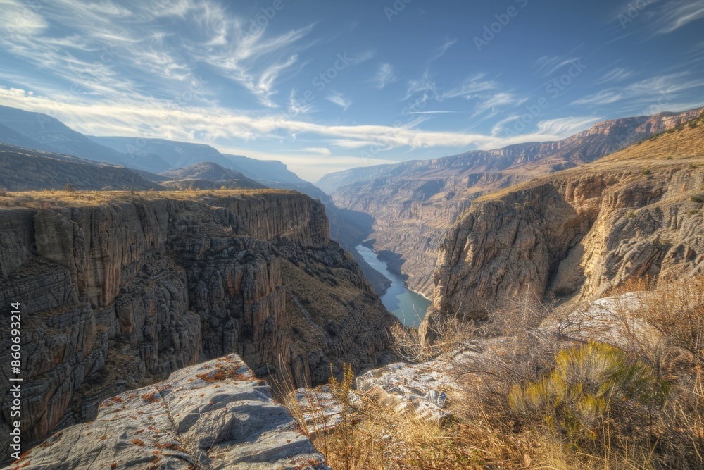 Poster a serene view of a canyon with a winding river flowing through it, perfect for use in travel or outd