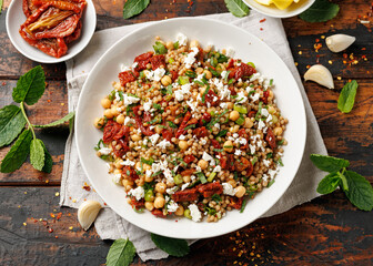 Pearl Couscous salad with sun dried tomatoes, chickpeas and feta cheese. healthy food