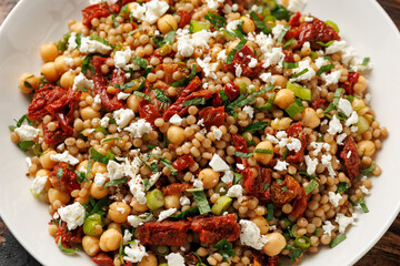 Pearl Couscous salad with sun dried tomatoes, chickpeas and feta cheese. healthy food