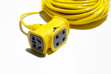 Yellow extension electric cable reel on white background.