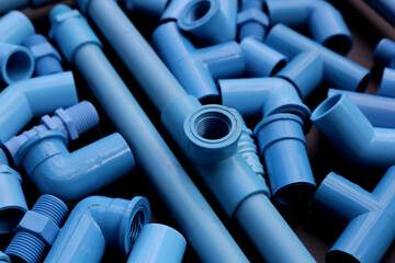 Plumber equipment with blue pvc pipe connections for plumbing work.