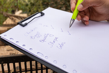 Hand writing inventory list of poultry farm products