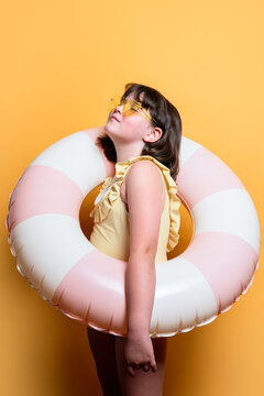 Young girl posing with inflatable swim ring, summer vibe