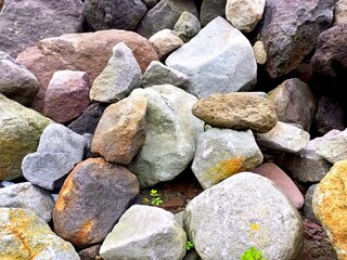 Texture background of stacked stones on the side of the road