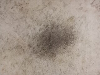 Gray smooth concrete wall with black stains