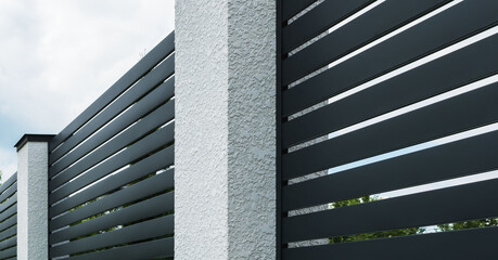 A fragment of a corrugated board fence on a private plot