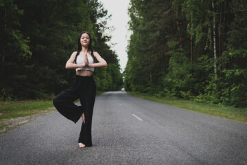 A young girl barefoot conducts gymnastics