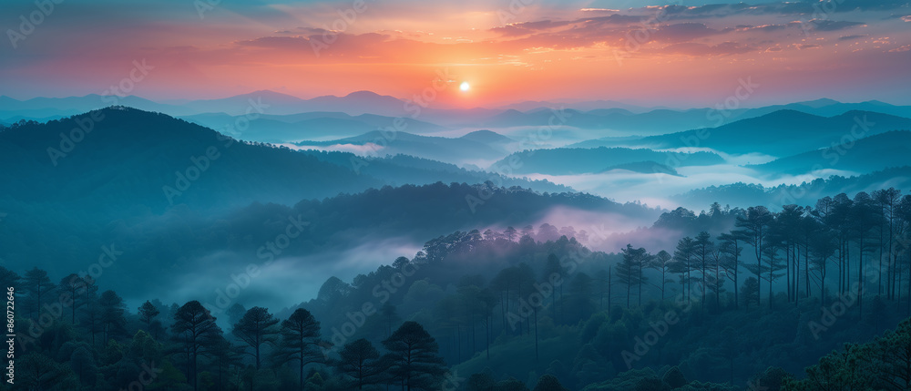 Aufkleber a beautiful mountain range with a sun setting in the background. the sky is a mix of blue and orange
