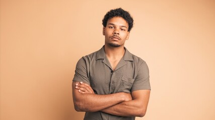 Confident man looking at camera in beige studio