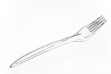 Disposable plastic fork. Disposable cutlery. Plastic dishes.