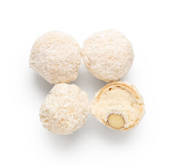Delicious chocolate candies with coconut topping isolated on white background