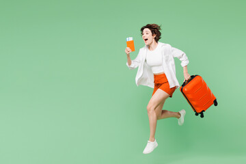 Full body traveler woman wear casual clothes hold passport ticket suitcase bag run fast hurry up...