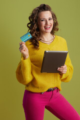 happy trendy woman in yellow sweater on green background