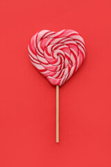 Sweet heart shaped lollipop on red background. Valentine's Day celebration