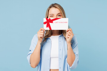 Young happy woman she wears white top shirt casual clothes hold gift certificate coupon voucher...