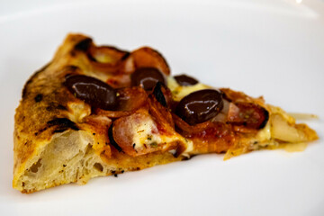 Calabrian sausage pizza served on a round board and set table