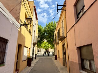 narrow alley with colorful houses in the old town of Torroella de Montgrí, Catalonia, Costa Brava, Girona, Spain