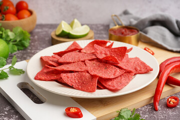 Composition with red nachos and chilli on table