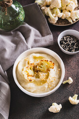 Vegetarian dietary cauliflower puree in a bowl on the table vertical view