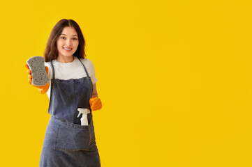 Young woman with sponge on yellow background